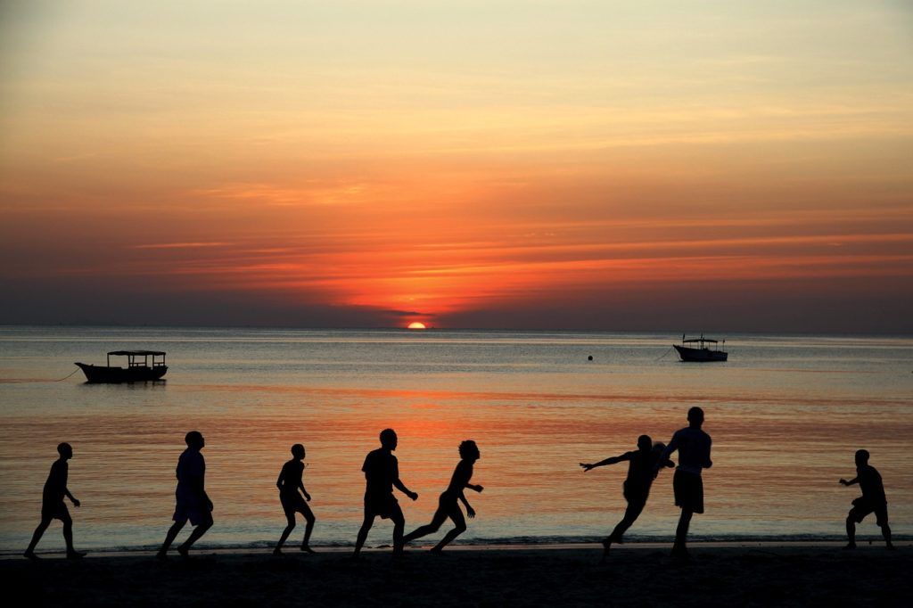 kids seen playing football on the beach while visiting zanzibar