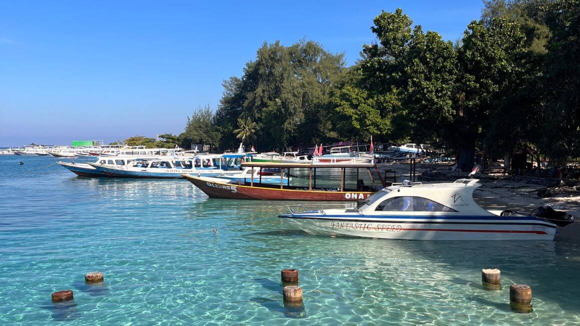 boats docked on the harbour in gili air, indonesia