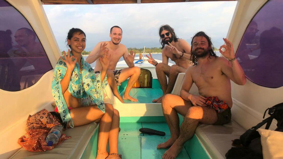 snorkeling crew on a boat trip around the gili islands, indonesia