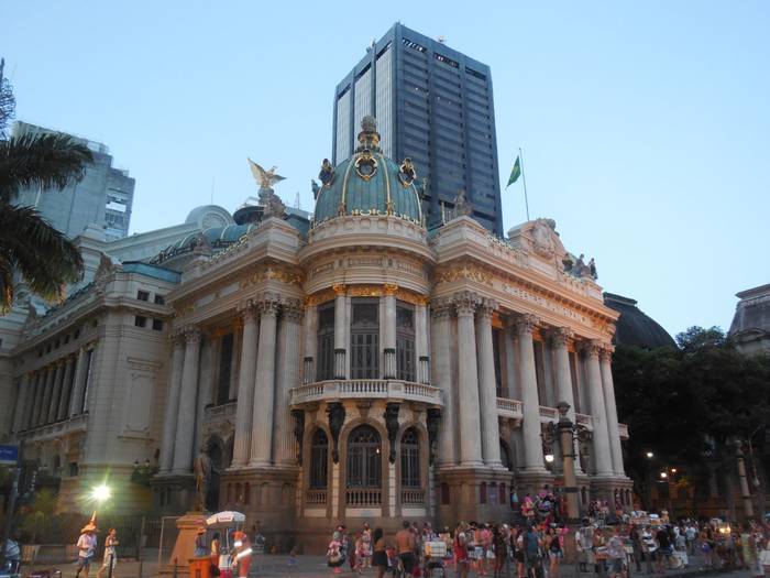 Theatro Municipal at dusk from street view, looking up at the blue and gold decoration of the building.  where to stay in Rio de Janeiro