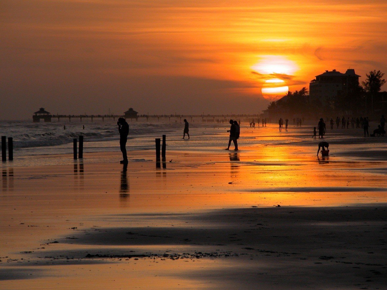 sunset on beach in florida people playing