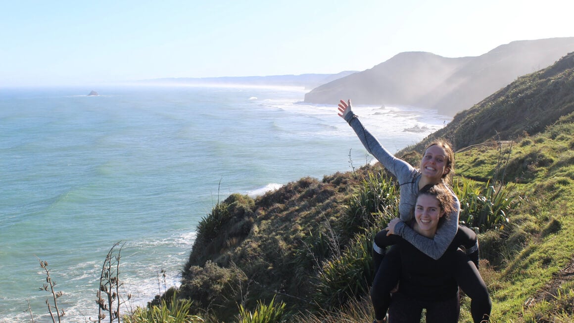 dani and friend hiking in auckland on the muriwai to bethells beach in new zealand