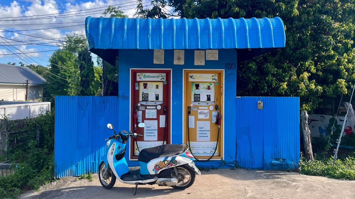 blue scooter bike at a gas station in pai, thailand