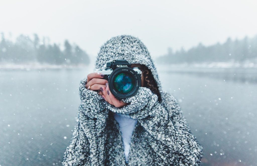 photographer in snow with nikon