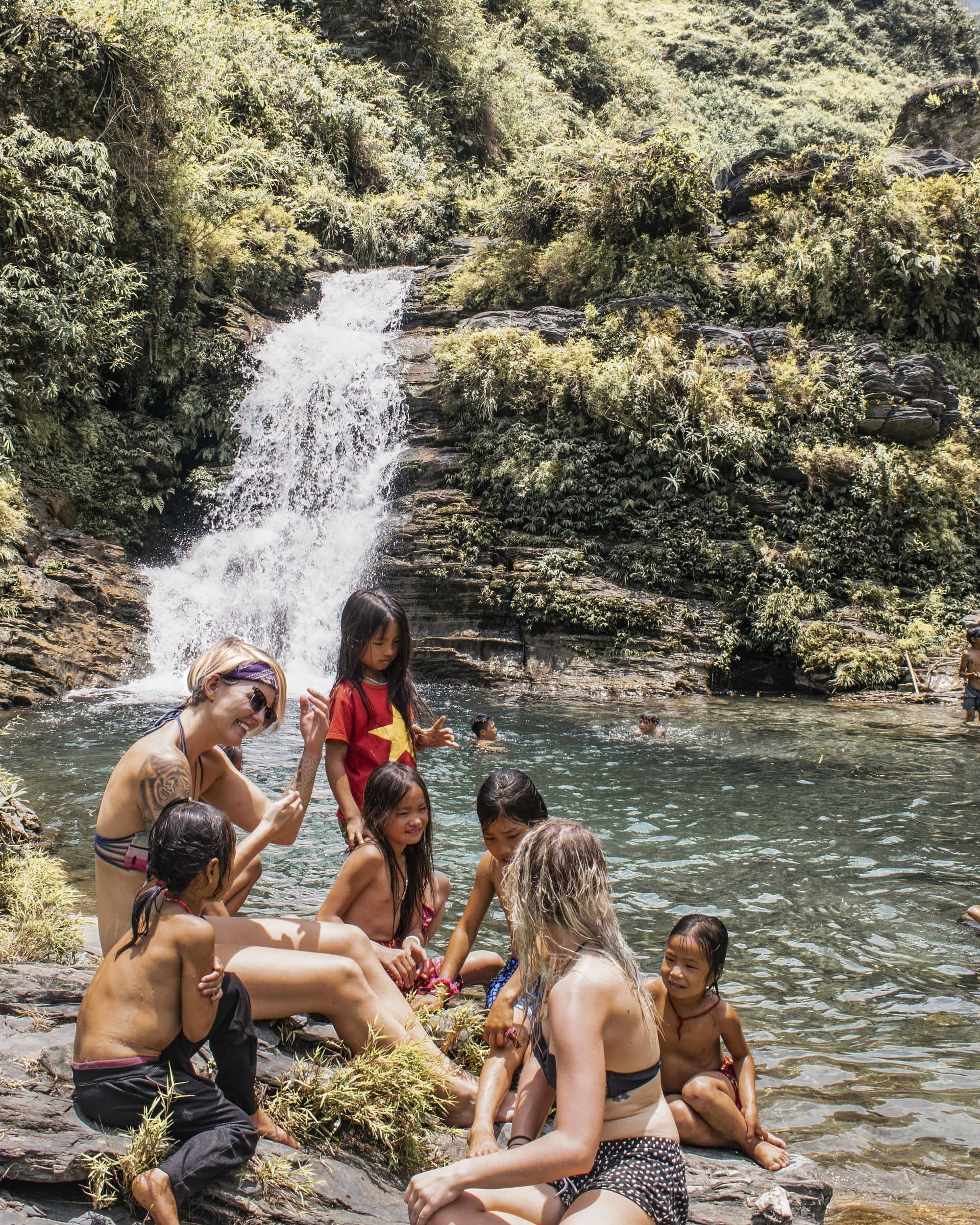 Locals at the waterfall in Heading out on day 5 on the Ha-Giang Loop.