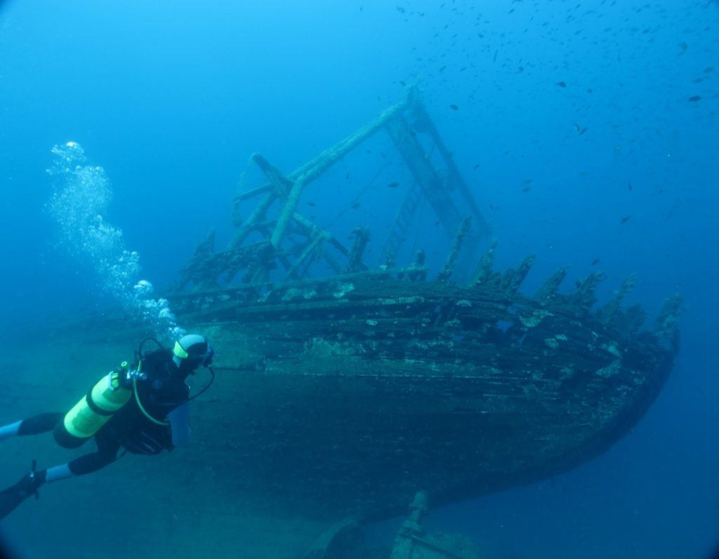 Scuba diver approaches a wreck. 