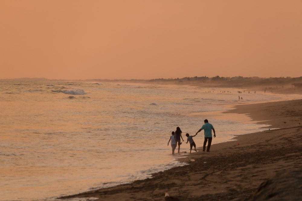 A family on a beach not fearing for their safety in Nicaragua
