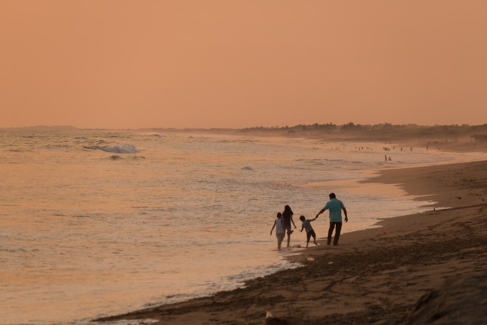 A family on a beach not fearing for their safety in Nicaragua