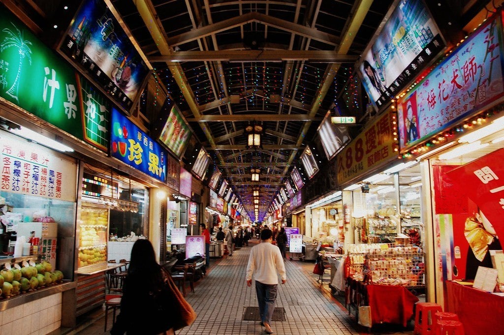 people walking through a night market in Wanhua, Taipei