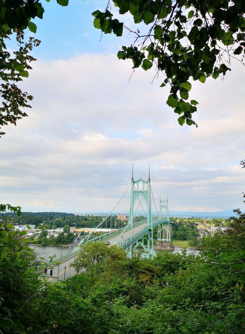 lush greenery framing a bridge while traveling in portland oregon