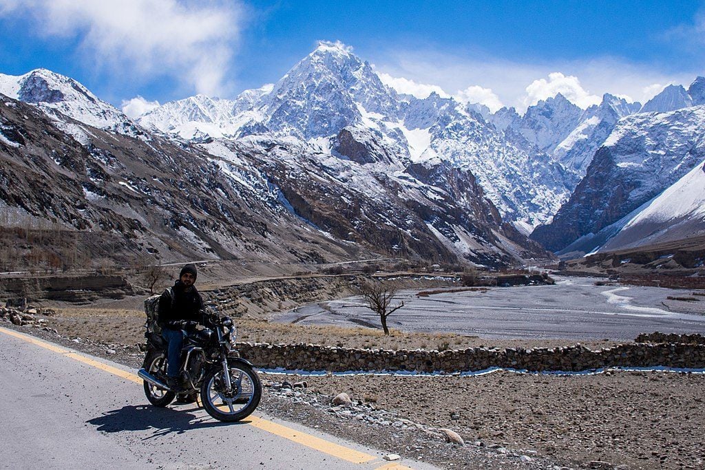 guy on motorbike on karakoram highway in pakistan