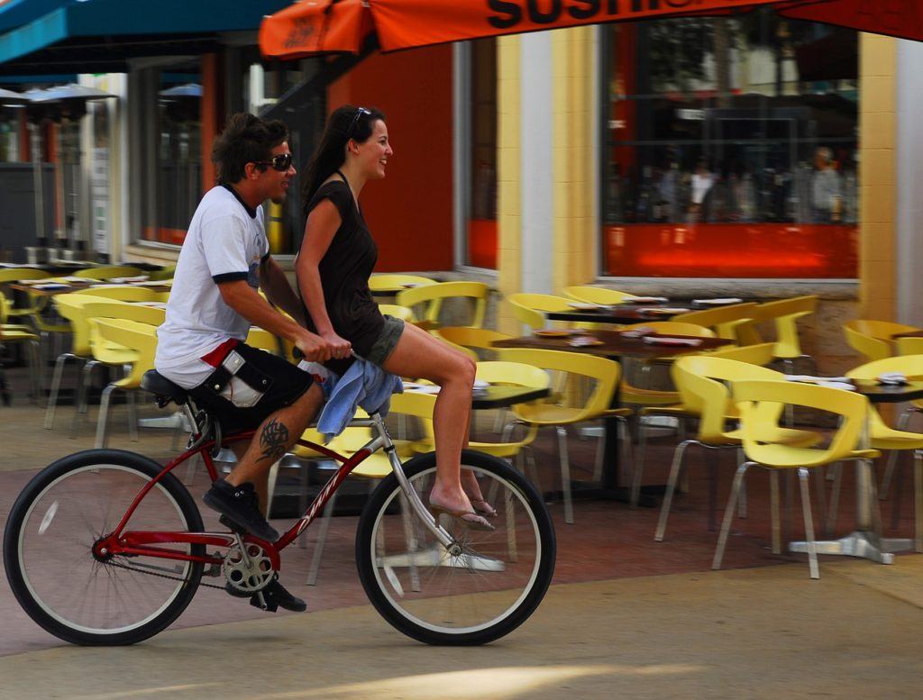 man and bike with girl miami travel guide
