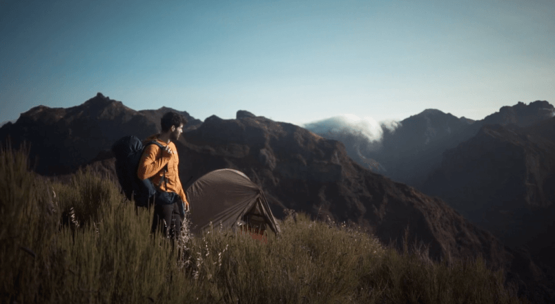 A man hiking with a cheap ultralight tent