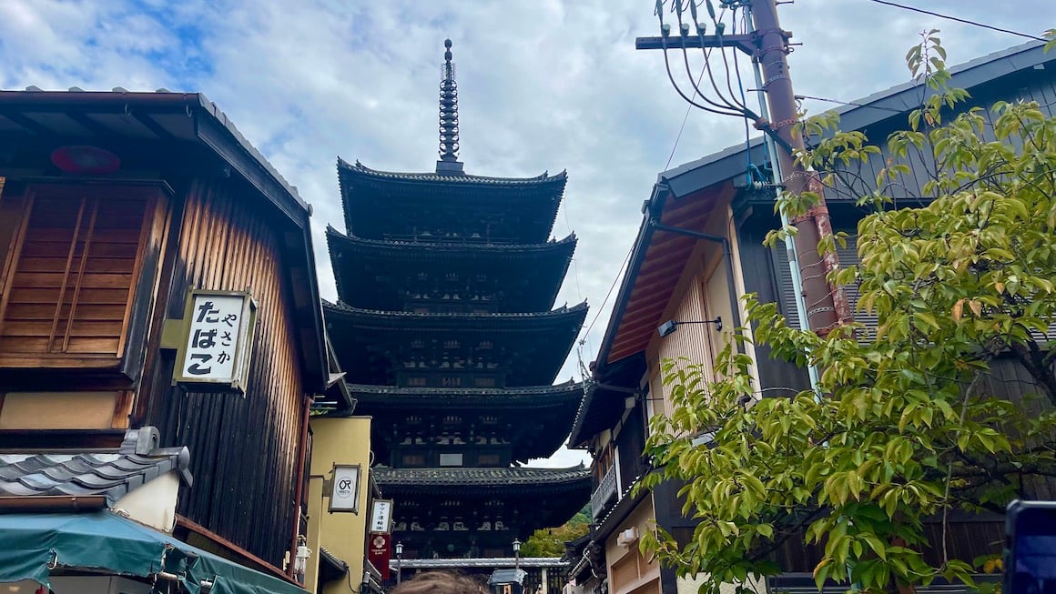 A pagoda stands tall over the streets of Kyoto, Japan.