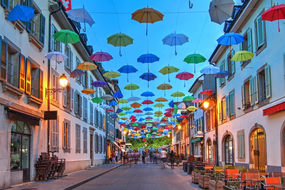 Street with colourful umbrellas hanging above in Carouge Geneva