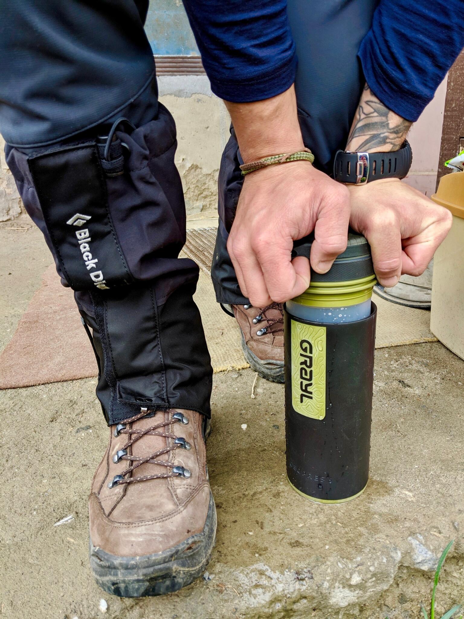 grayl water bottle being pressed and filtered