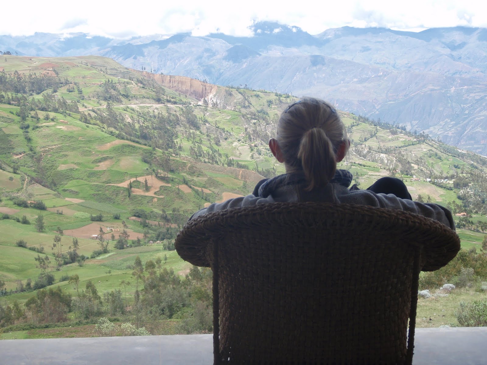 Female traveler admiring the view of the Cordillera Negra in Peru from a lodge balcony