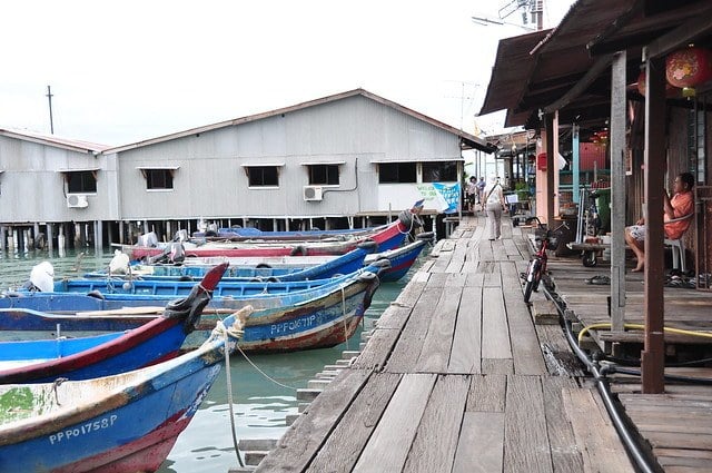wooden boats floating at the Penang Clan Jetty