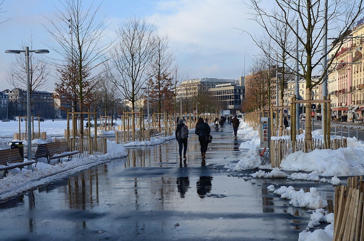 Pedestrians walking in the snowy streeta of Plainpalais, Geneva