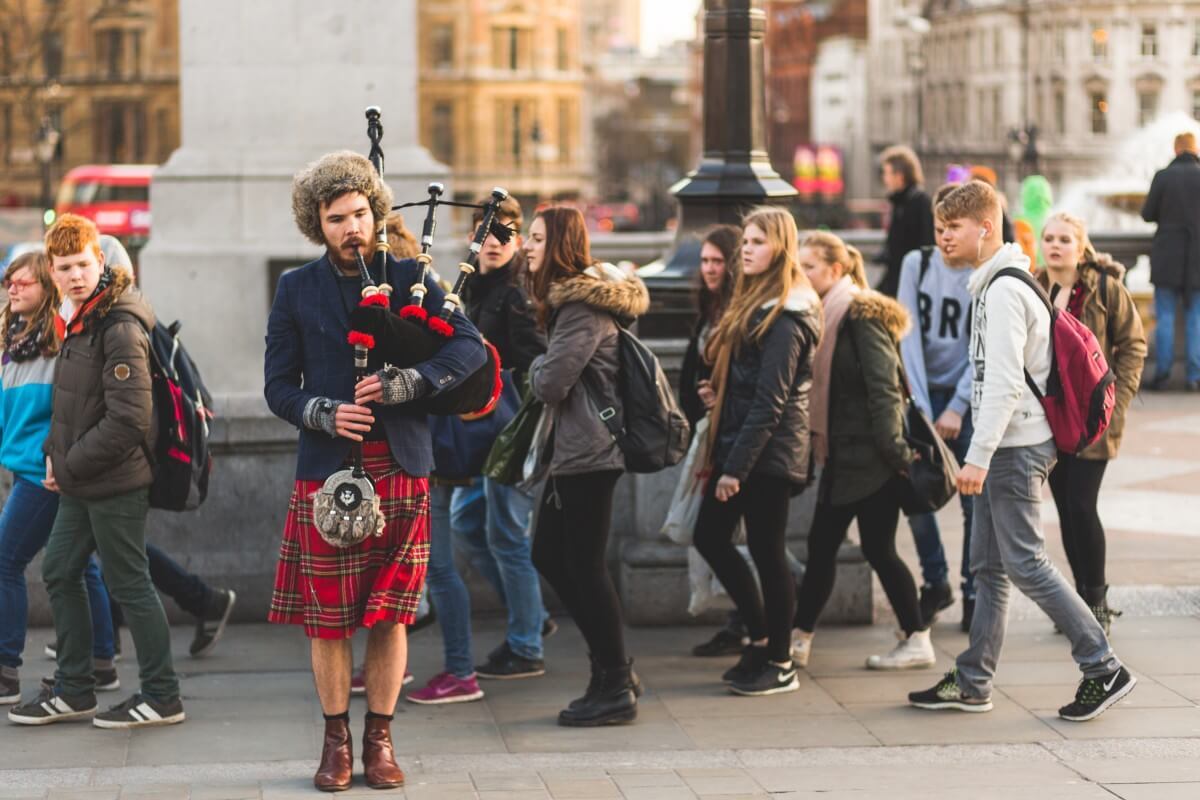 Street performer playing bag pipes