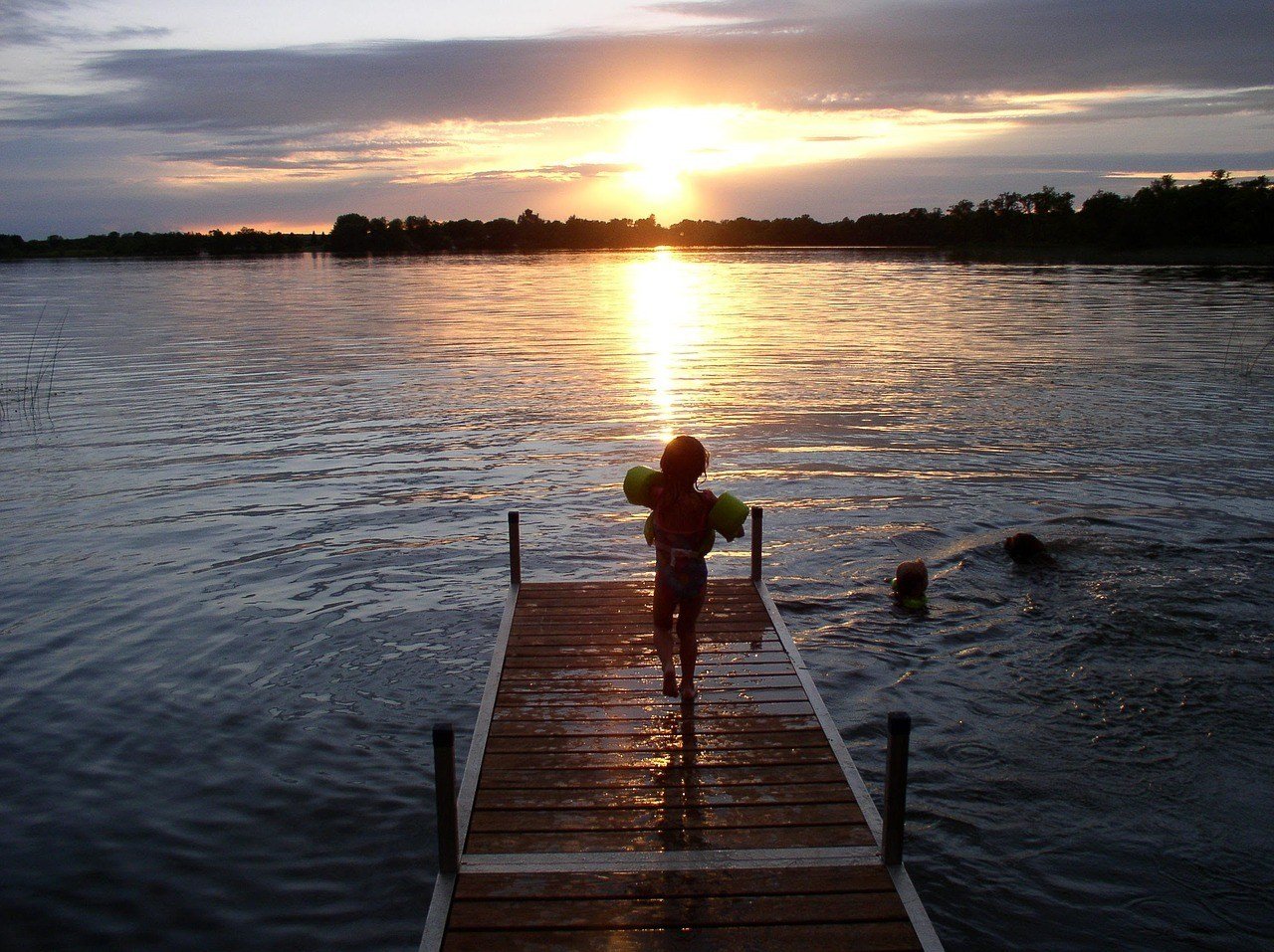 Kid venturing from the campsite to swim