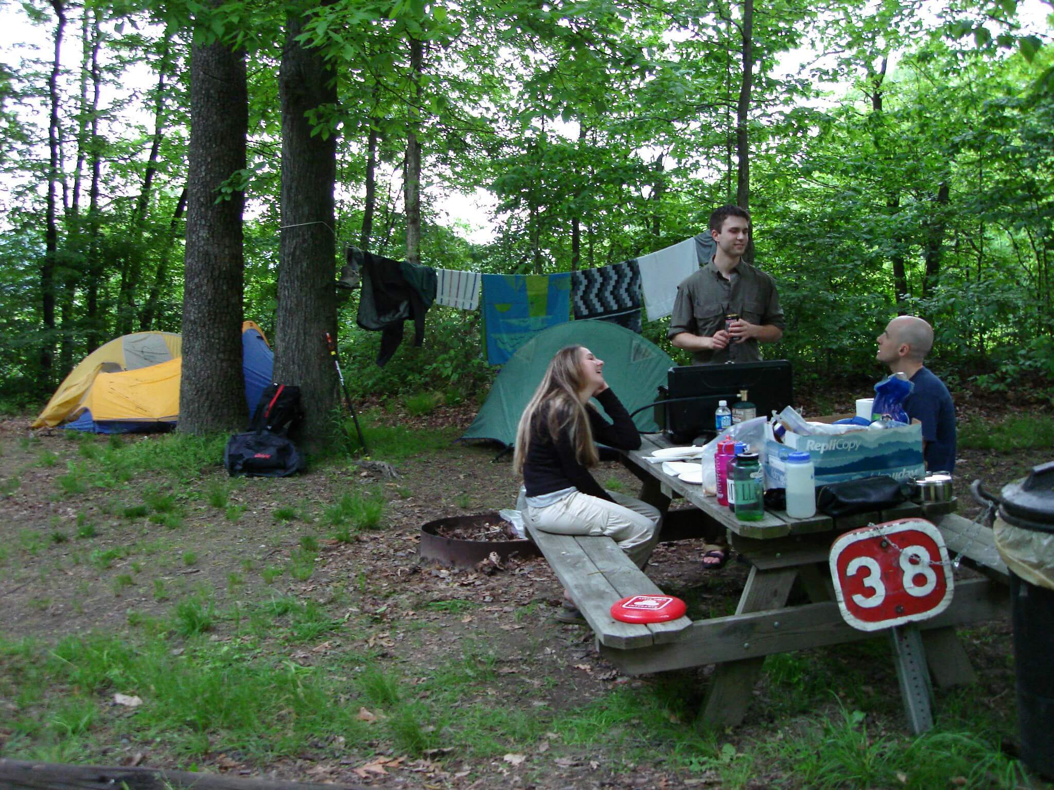A group sitting around the camp table in chairs