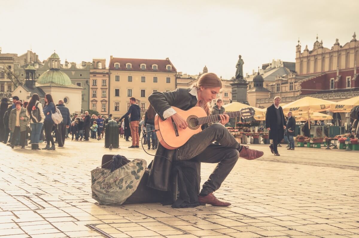 Street performer busking with a guitar