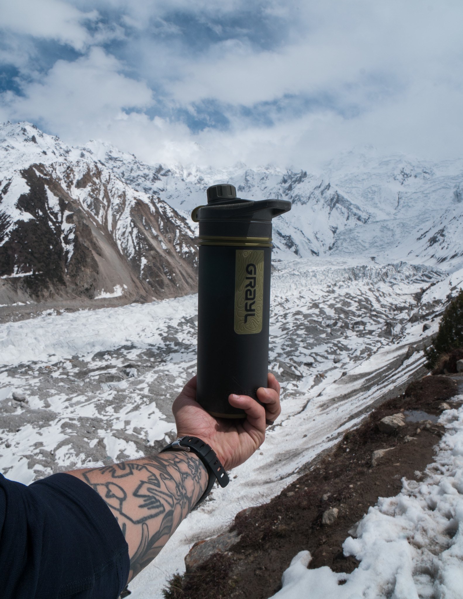 Grayl water bottle backdropped against a gorgeous sky