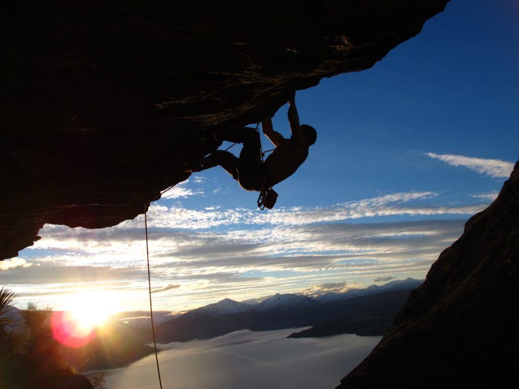 A traveller rock climbing in the Remarkables near Queenstown