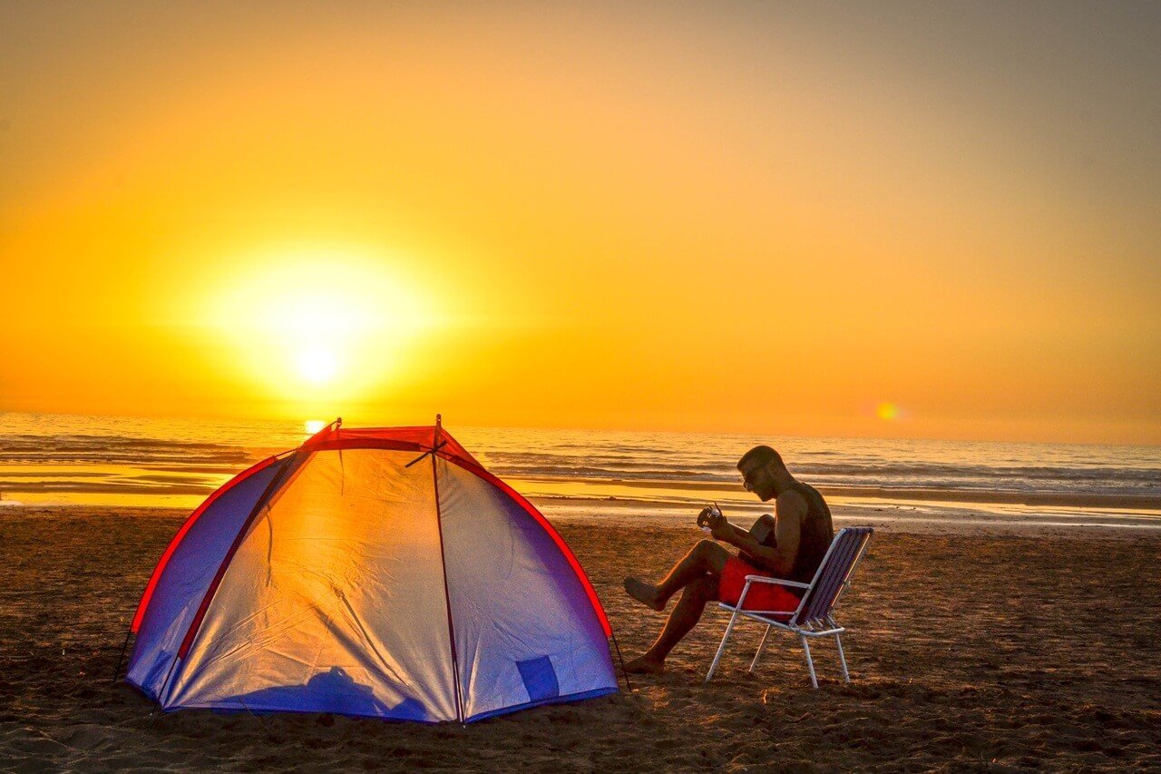 A budget backpacking tent camping on the beach