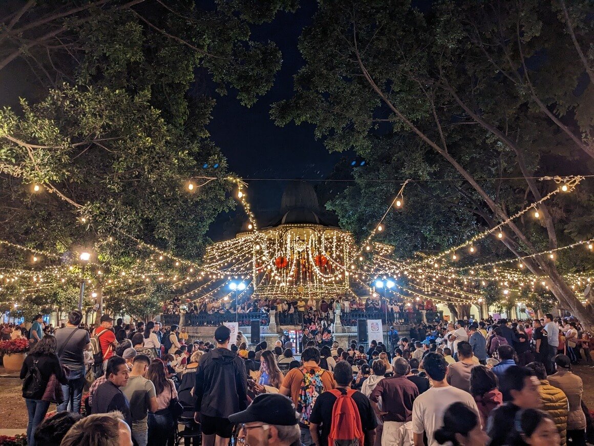 fairy lights decorating the central pavillion surrounded by people