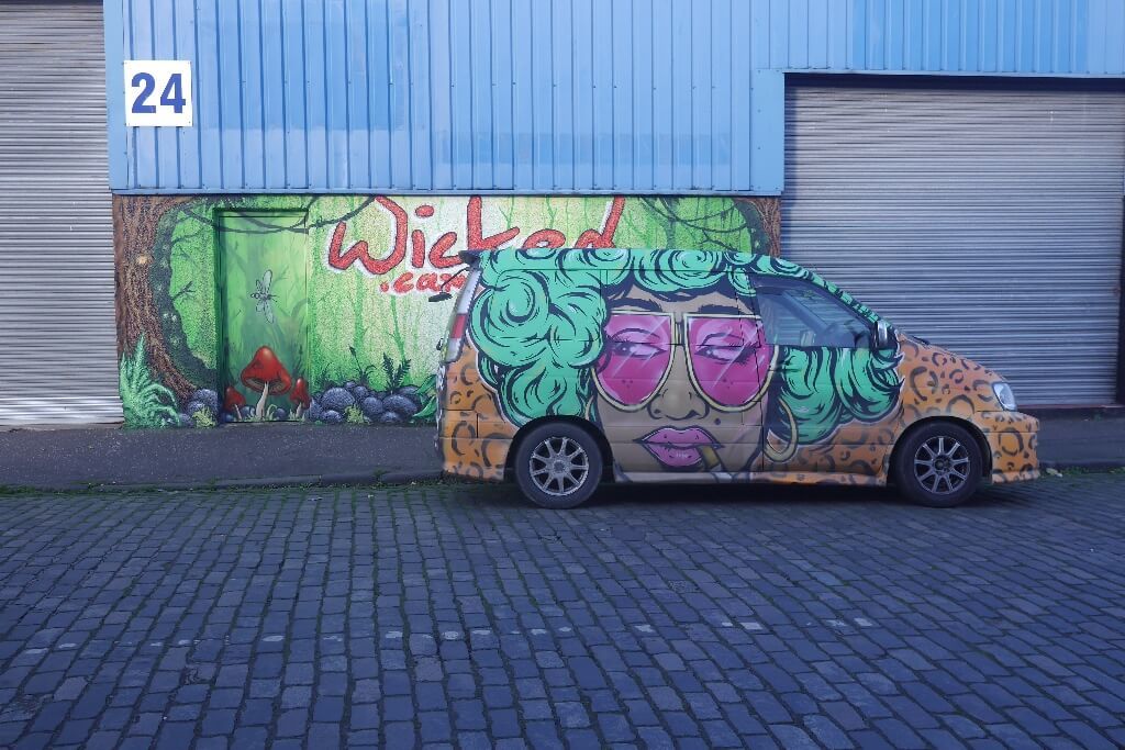 A parked rental Wicked campervan on a driving tour of South Island