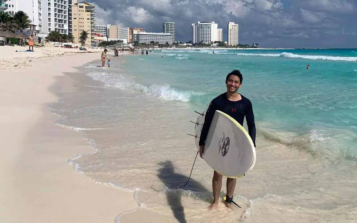 Friendly surfer local on cancun beach in Cancun mexico.