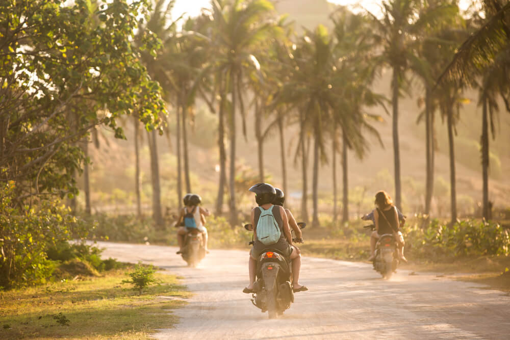 people traveling around bali on scooter