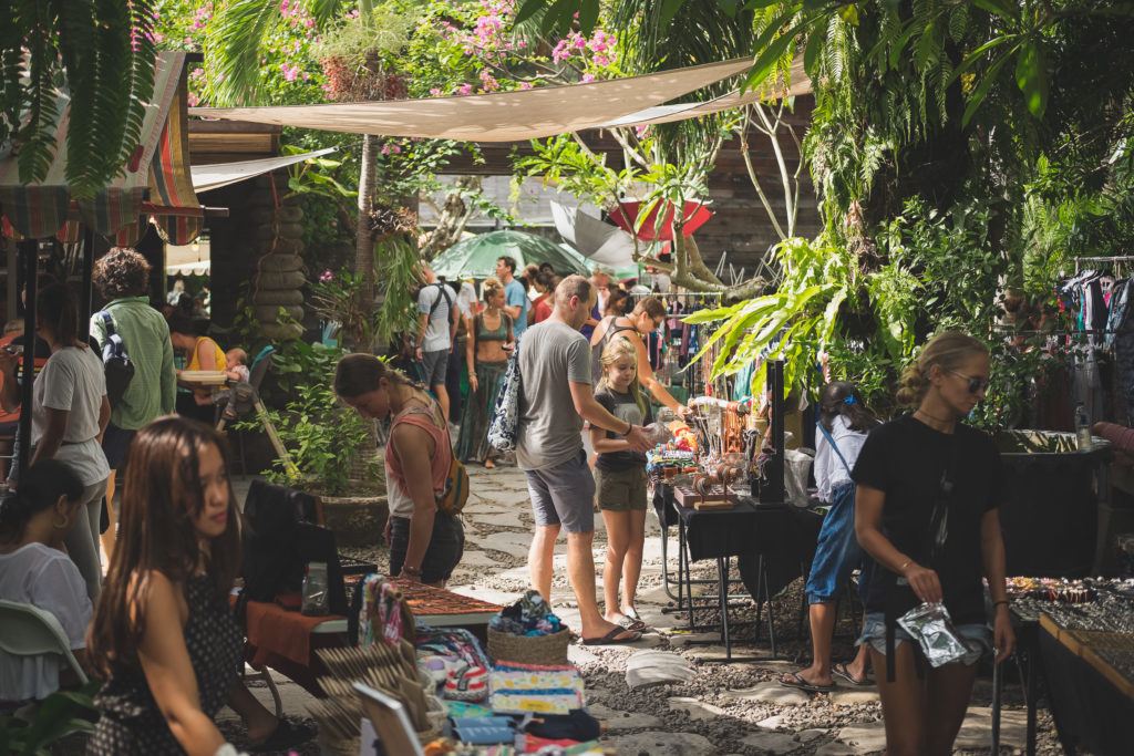 travelers buying handmade goods at an organic farmer's market in canggu bali