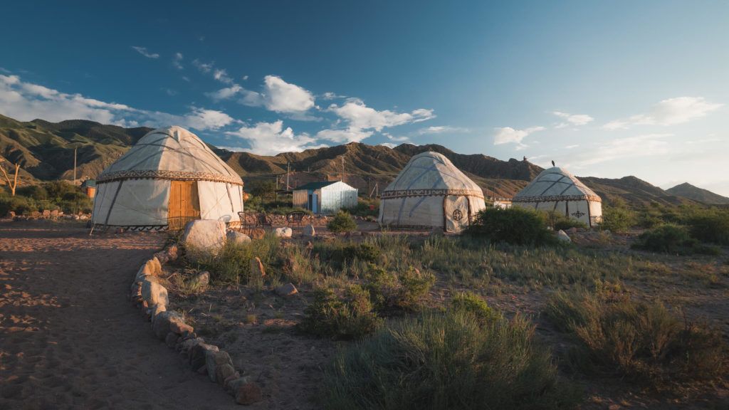 three white yurts which are also a type of airbnb experience