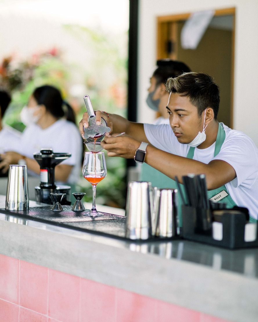 bartender pouring a cocktail at tribal hostel