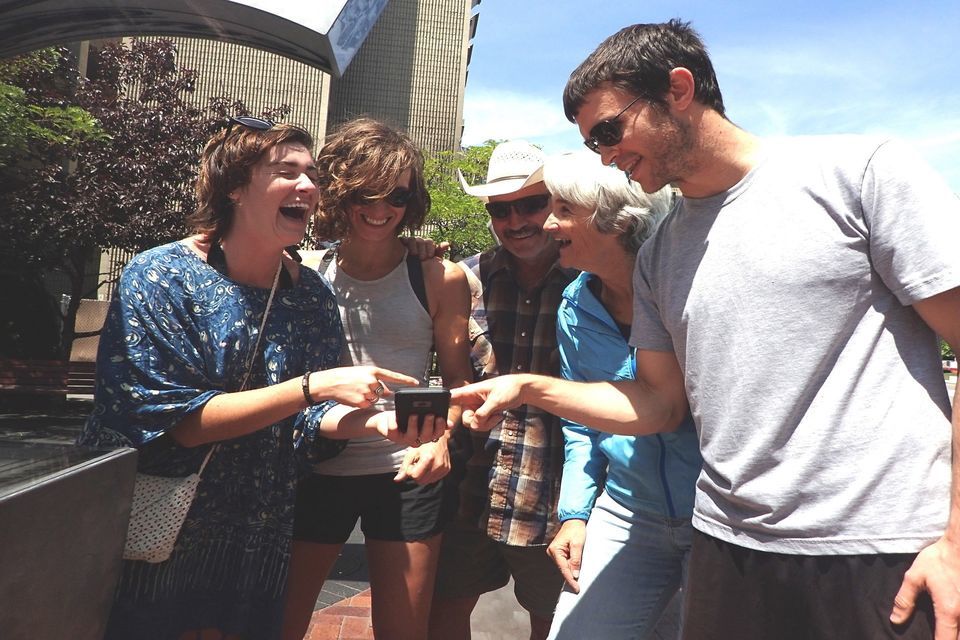 Group of five people having fun during a scavenger hunt around Indianapolis