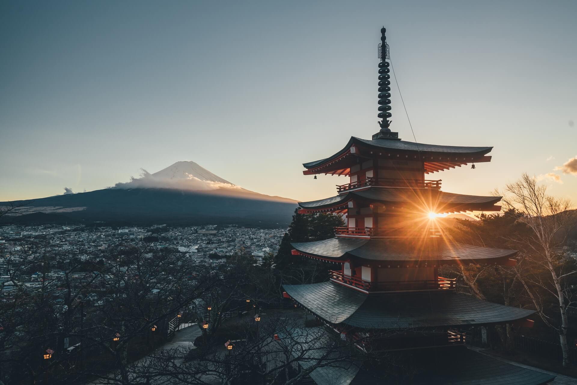 A temple and Mt Fuji in the background photographed by someone travelling in a van in Japan