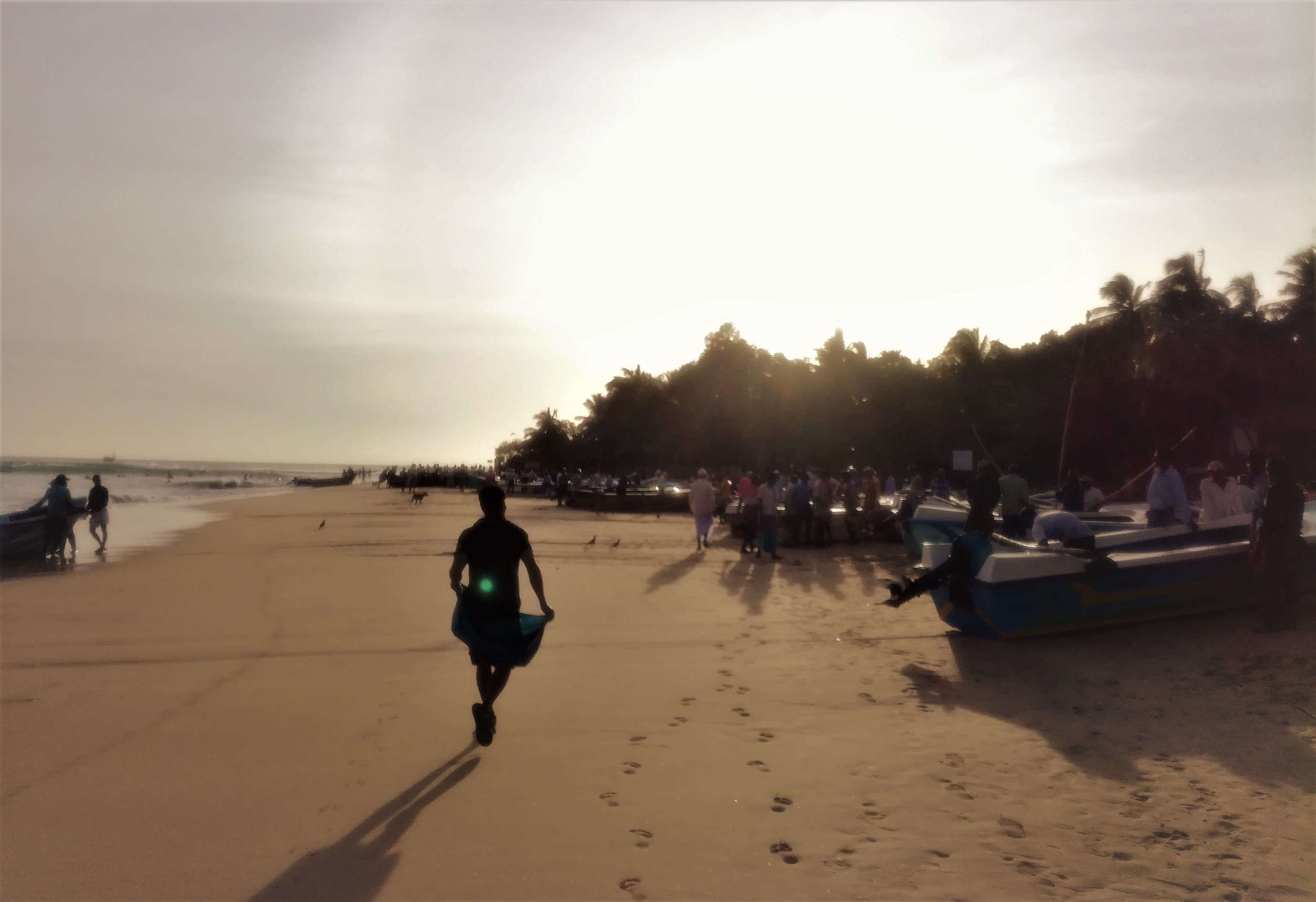 A local at sunrise on the beach in Arugam Bay