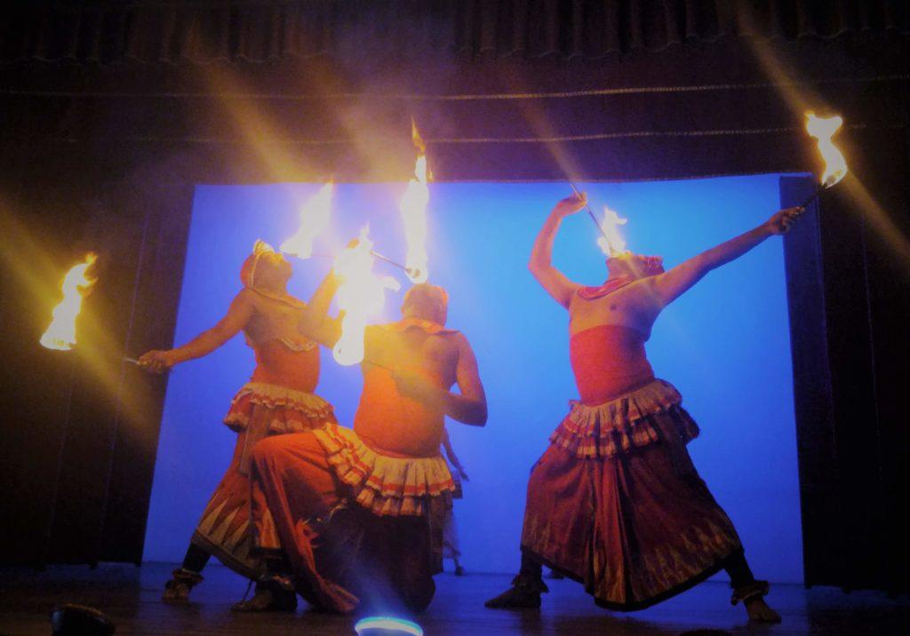 Three dancers breathe fire at a festival in the Cook Islands