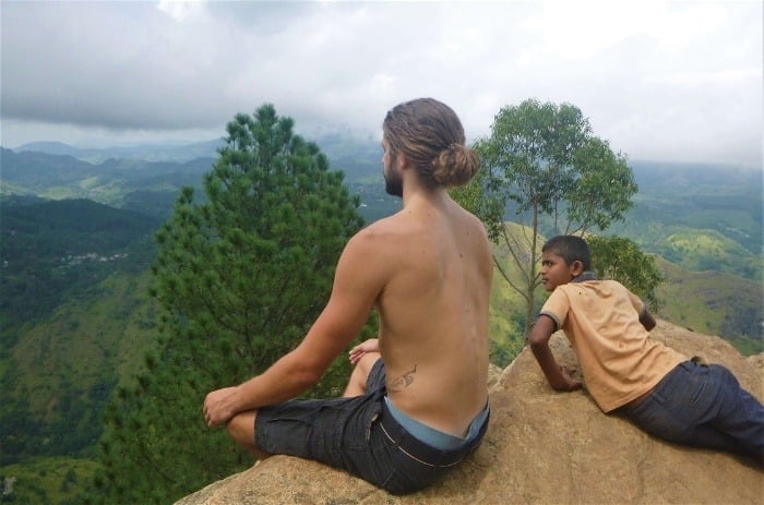 A fellow backpacker in Sri Lanka meditating at a viewpoint in Ella