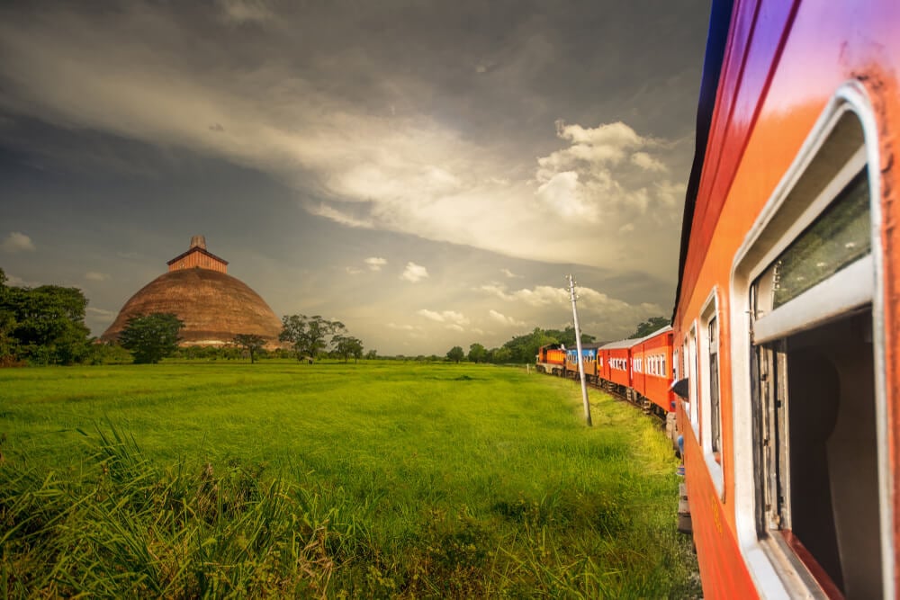 A train in Sri Lanka passing a popular cultural tourist attraction