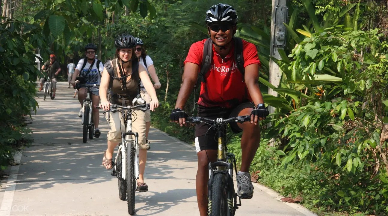 People biking through the jungles of Bangkok.