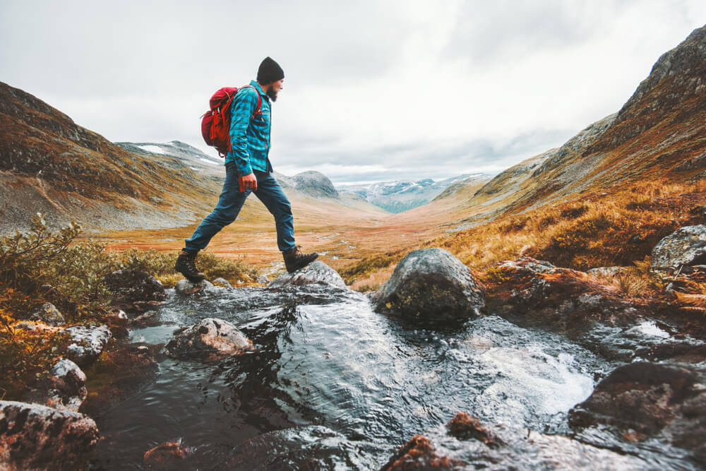 A man hiking with a lightweight daypack