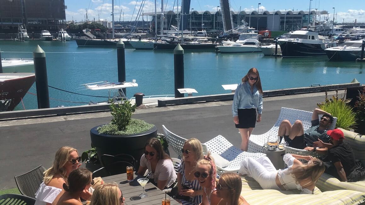 dani and friends having a drink on the viaduct in auckland, new zealand