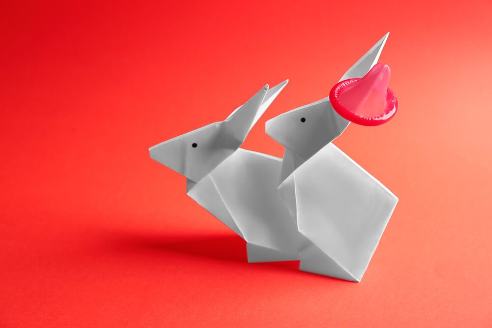 Origami rabbits practising safe sex