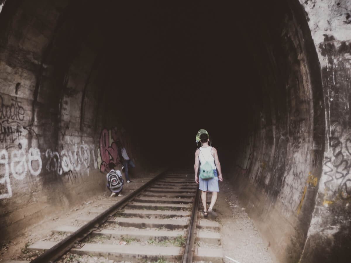 A tourist visiting attractions in Sri Lanka - the Nine Arch Bridge tunnel