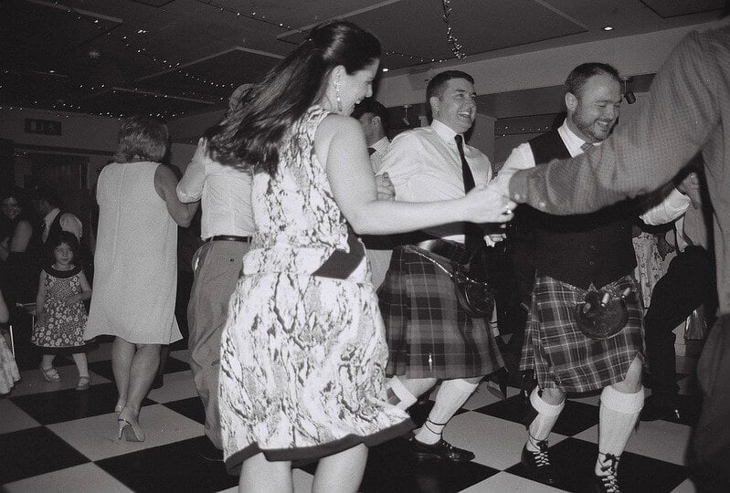 People dancing a Scottish ceilidh at a pub in Glasgow