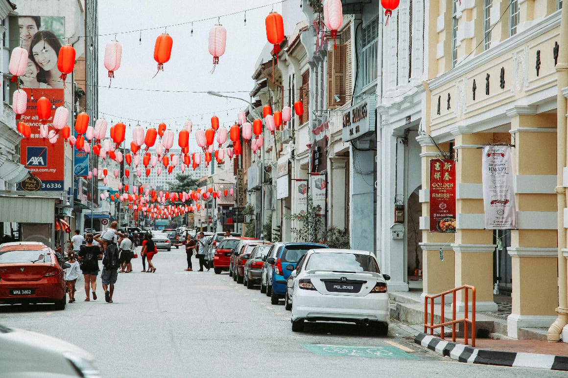 lanterns down a busy street in george town